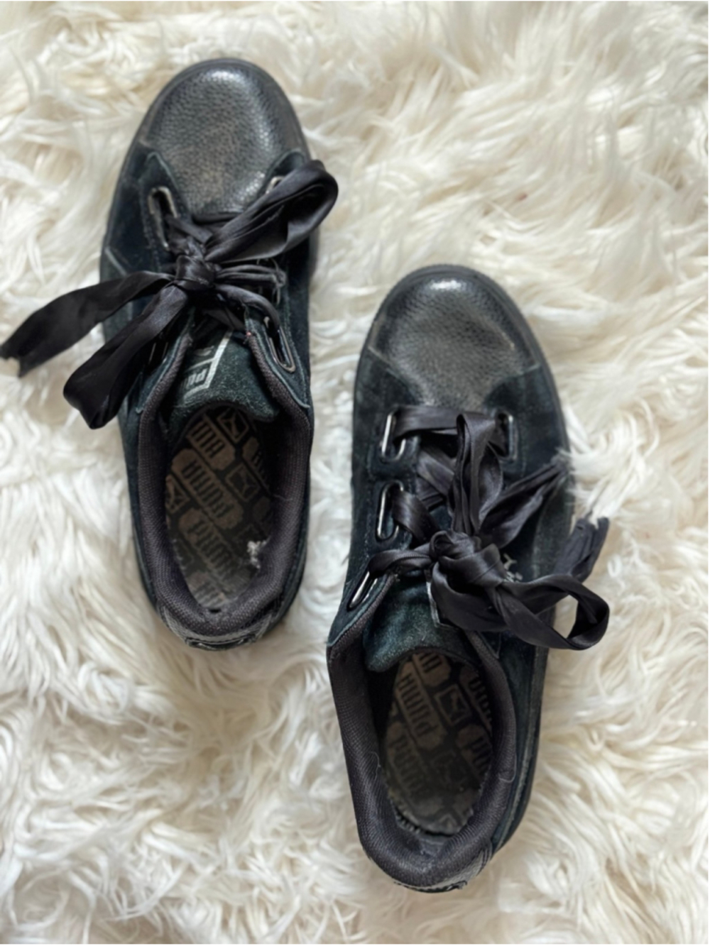 Well worn woman's aged puma sneakers